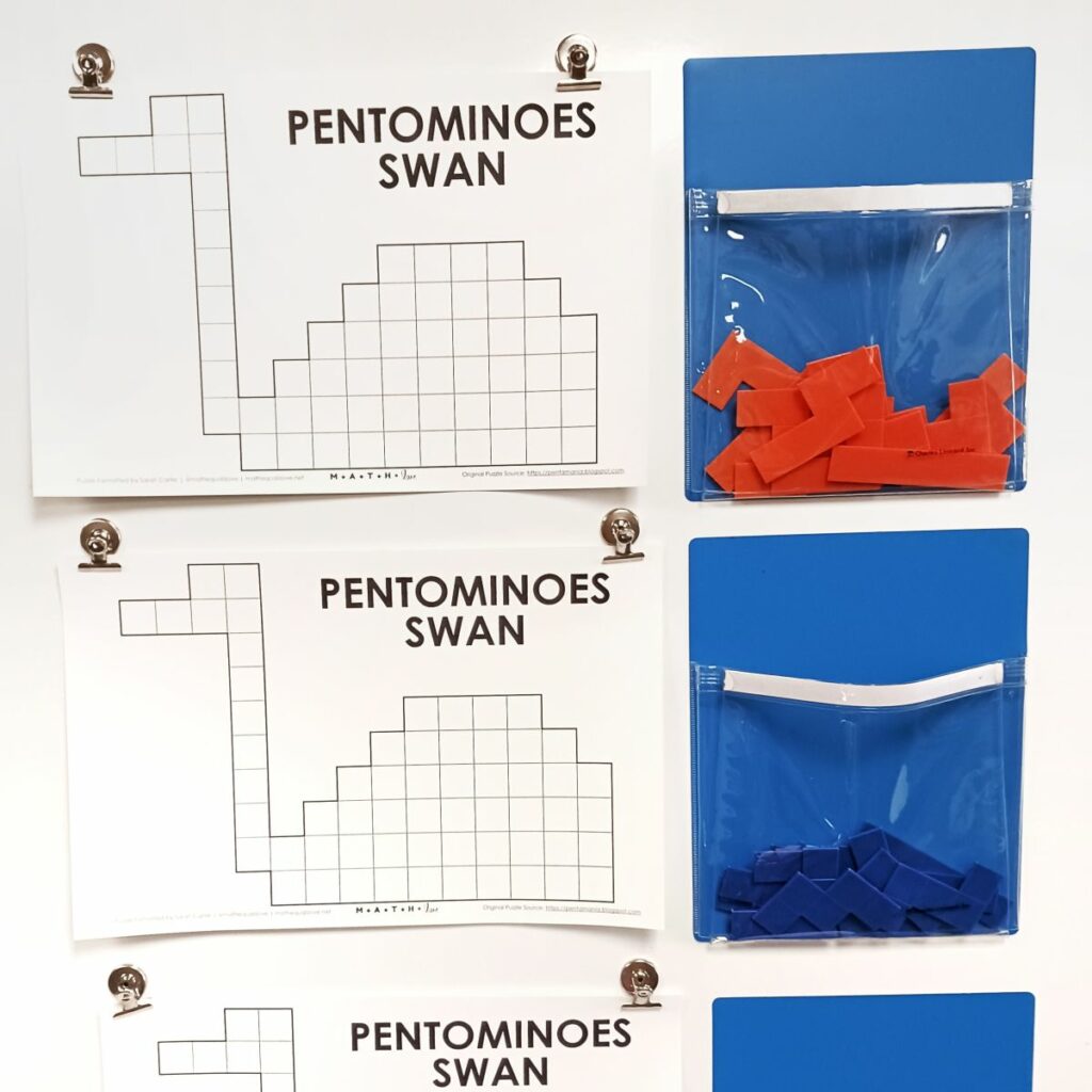 pentomino swan puzzle hanging on dry erase board in classroom. 