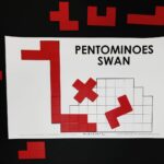 partially solved pentomino swan puzzle.