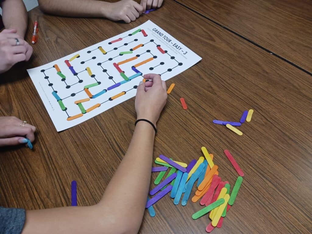 students working on jumbo grand tour puzzle in groups.