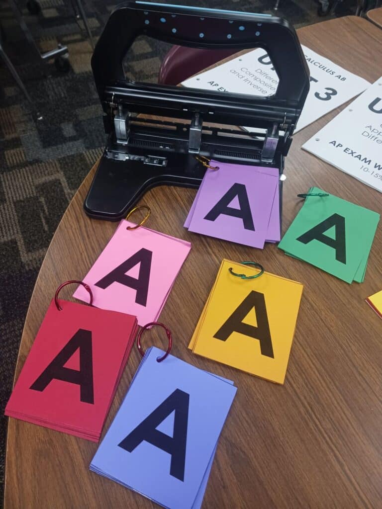 punched multiple choice letter cards on rings.